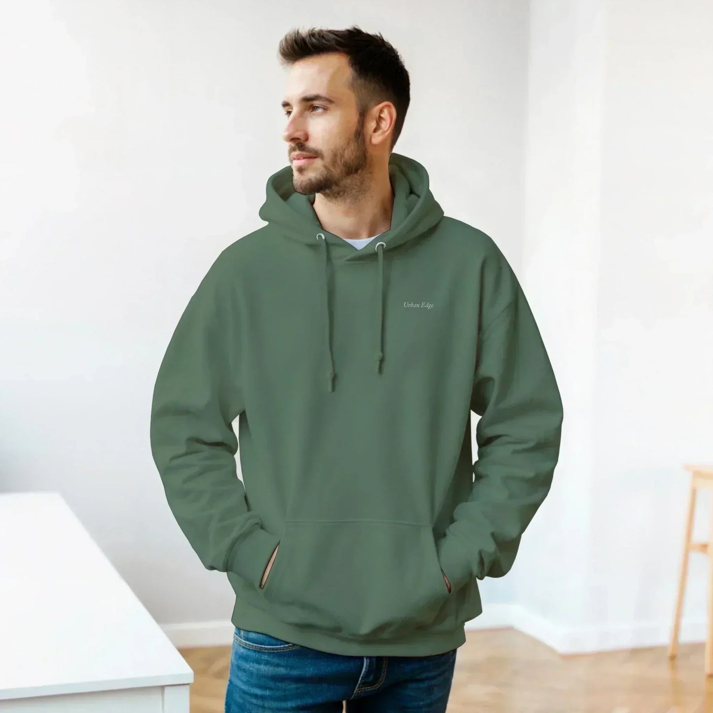 Man wearing green Gildan® 18500 classic unisex pullover hoodie with front pouch pocket and drawstring hood indoors